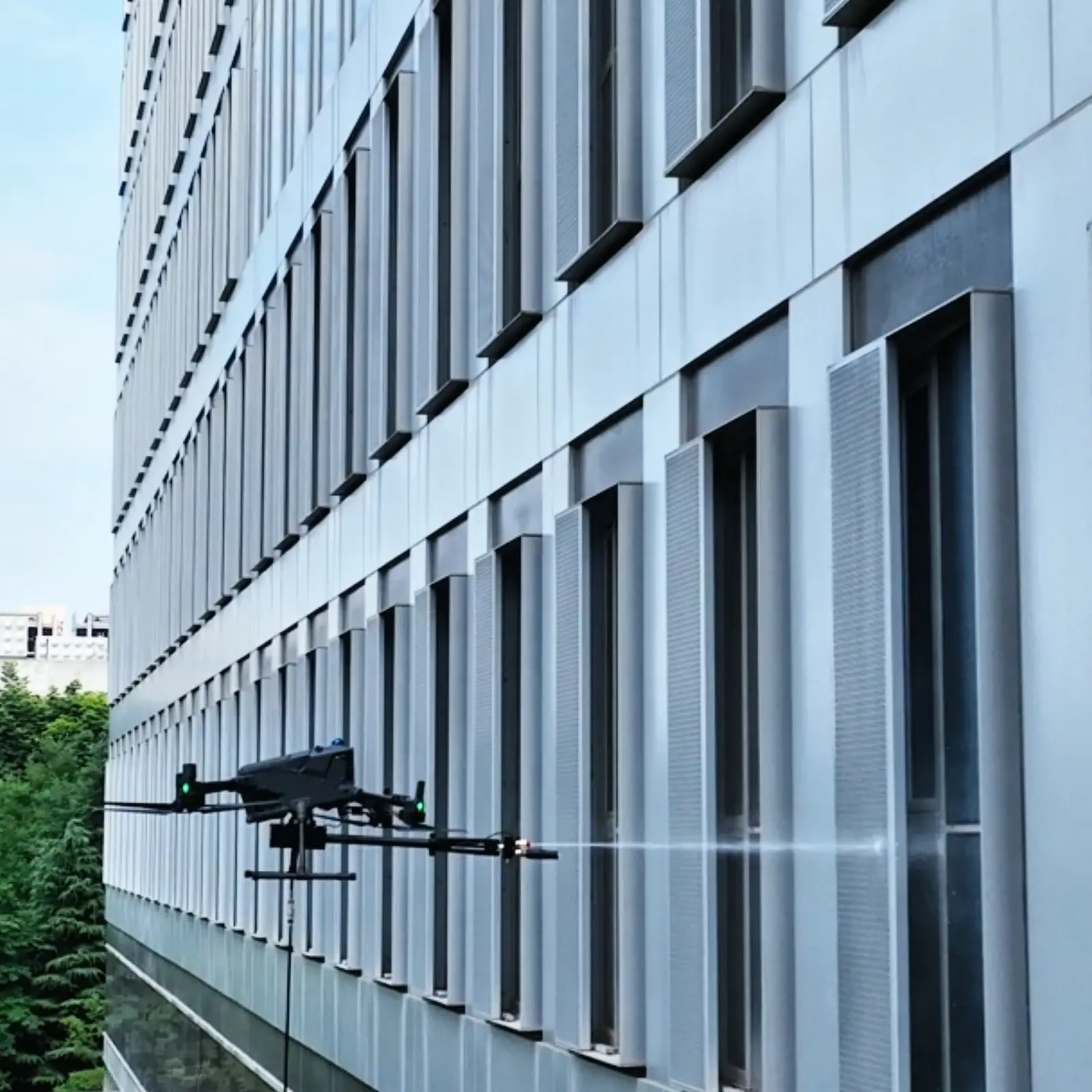HoverWash 3 completing a controlled horizontal facade-cleaning pass